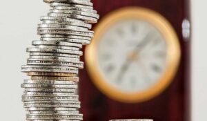 Coins with clock in the background