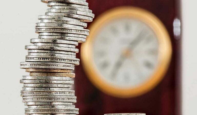 Coins with clock in the background