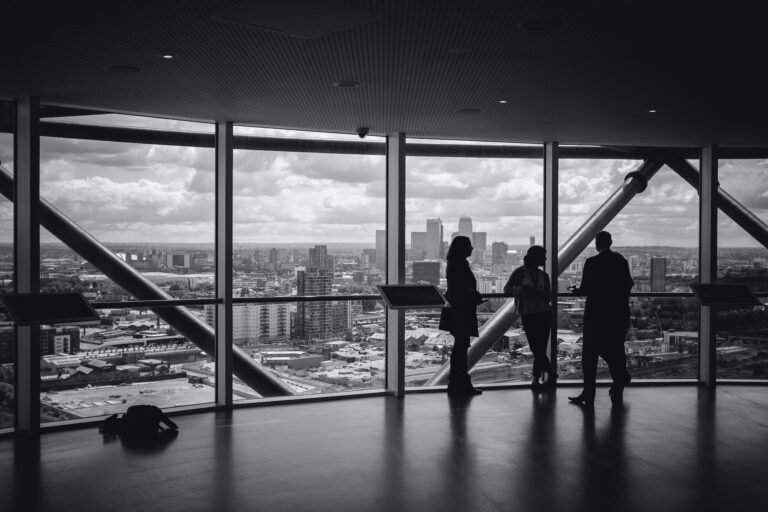 office space with a city view and shadows images of 3 people talking